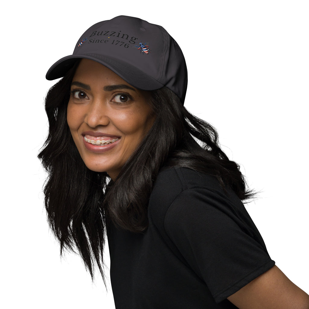 Dark gray dad hat with embroidered text and small bee patch on the front.