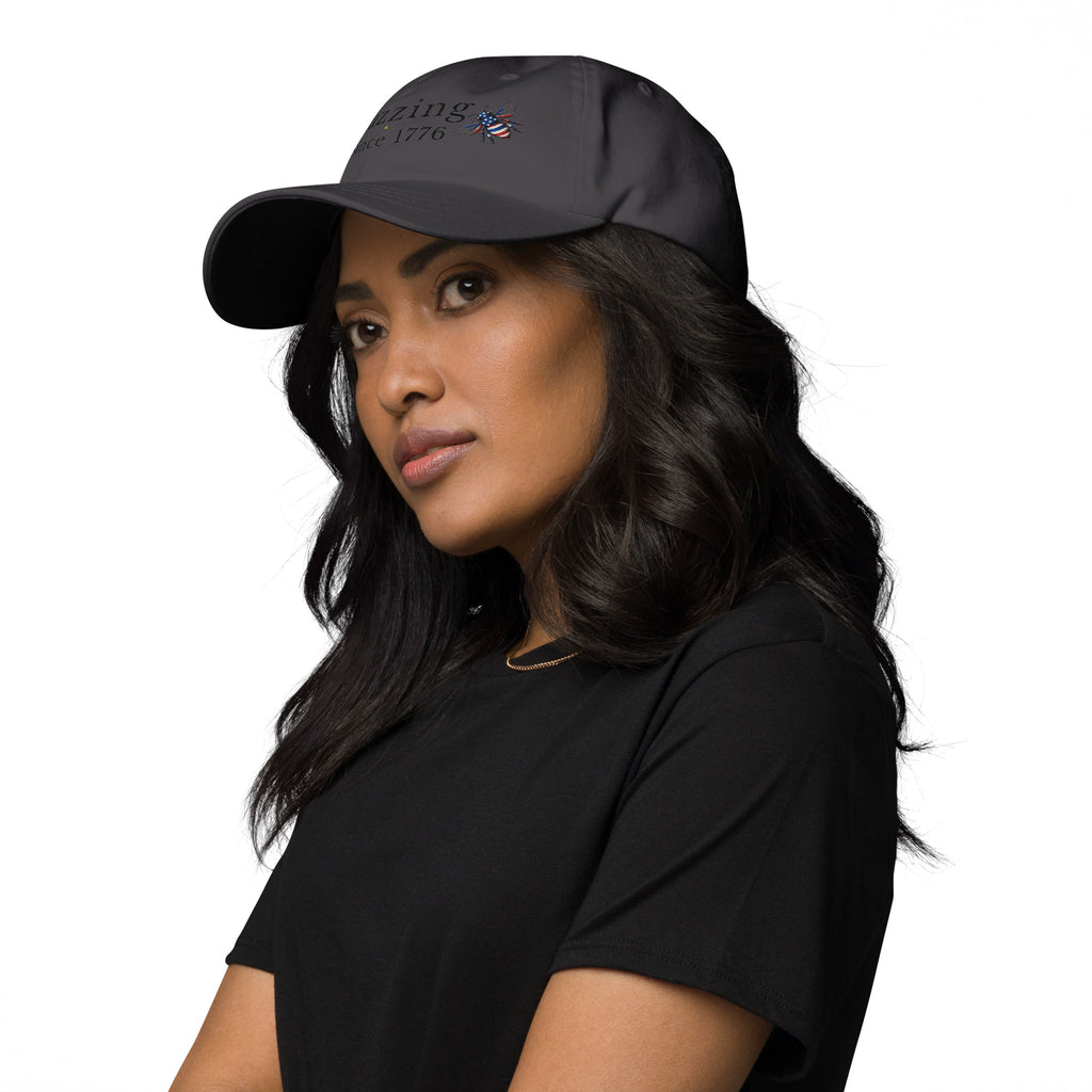 Charcoal gray dad hat with embroidered logo and small bee patch on the front.