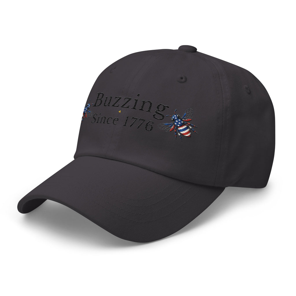 Dark grey dad hat with “Buzzing Since 1776” and bee graphic