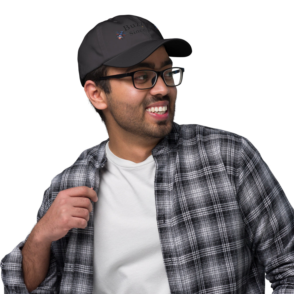 Dark grey dad hat with embroidered bee and “Buzzing Since 1776” text