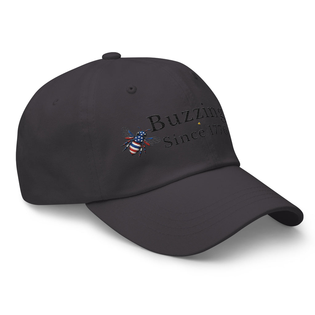 Dark gray dad hat with embroidered “Buzzing Since 1776” and bee emblem
