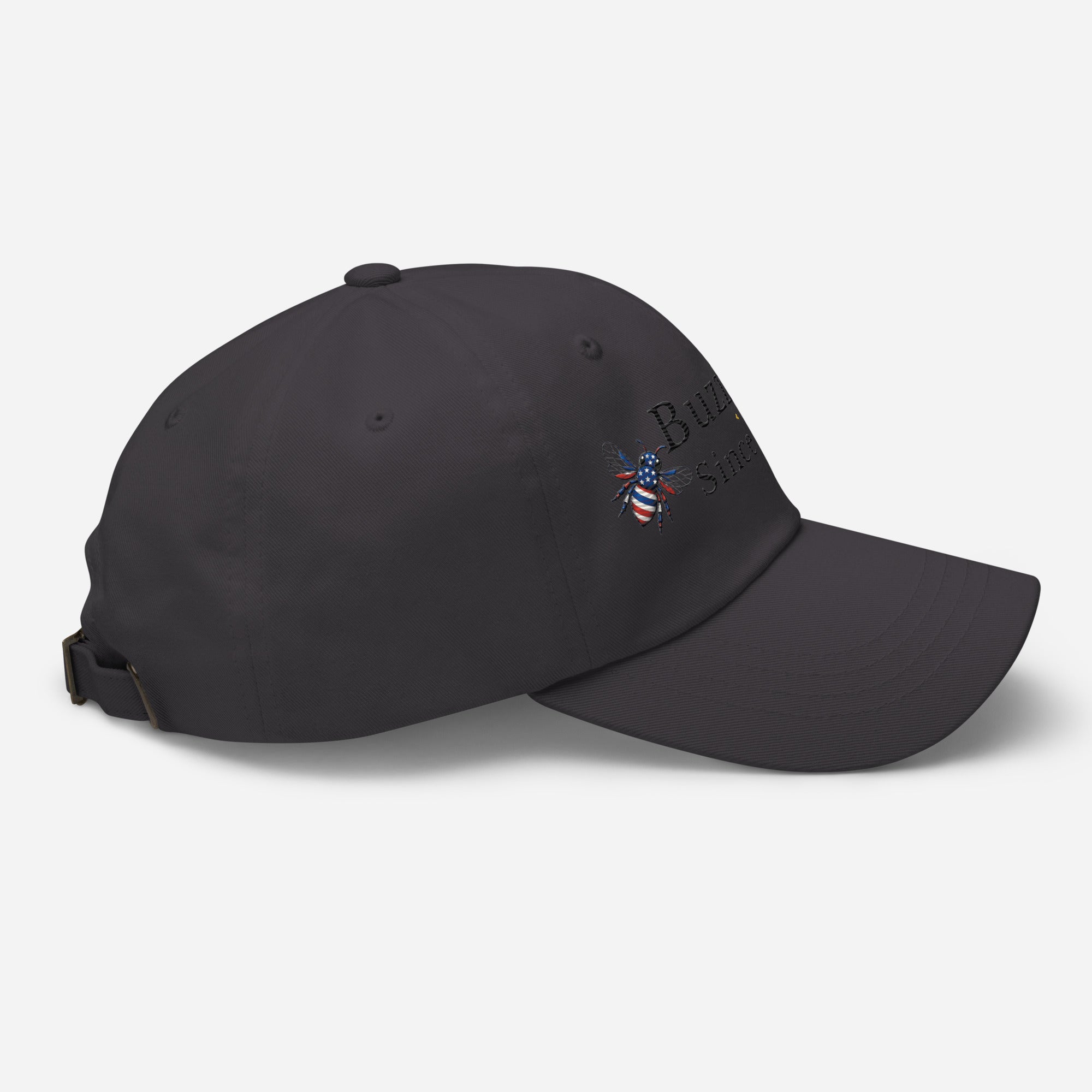 Dark grey dad hat with adjustable strap and embroidered emblem on side