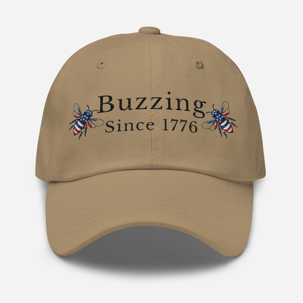 Khaki dad hat with “Buzzing Since 1776” text and bee graphic embroidery on front