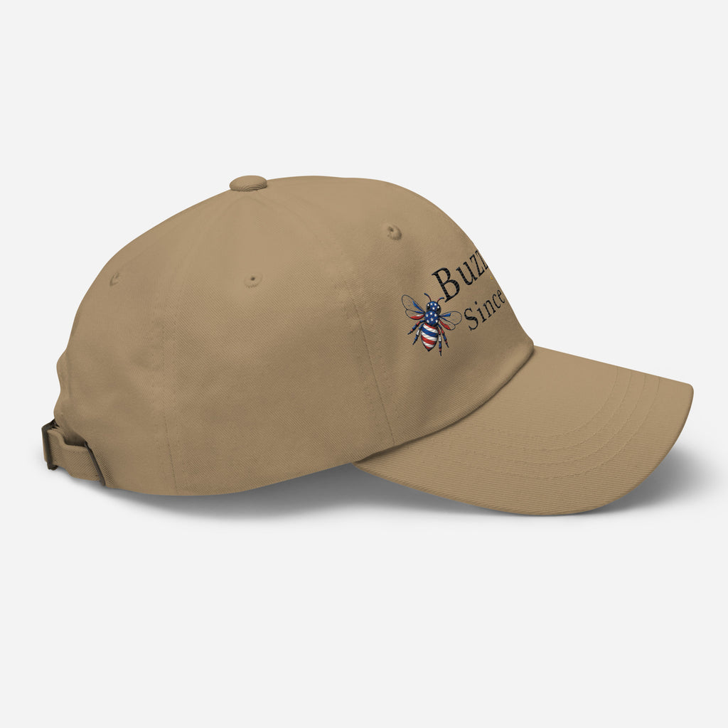 Khaki dad hat with adjustable strap and embroidered emblem on side