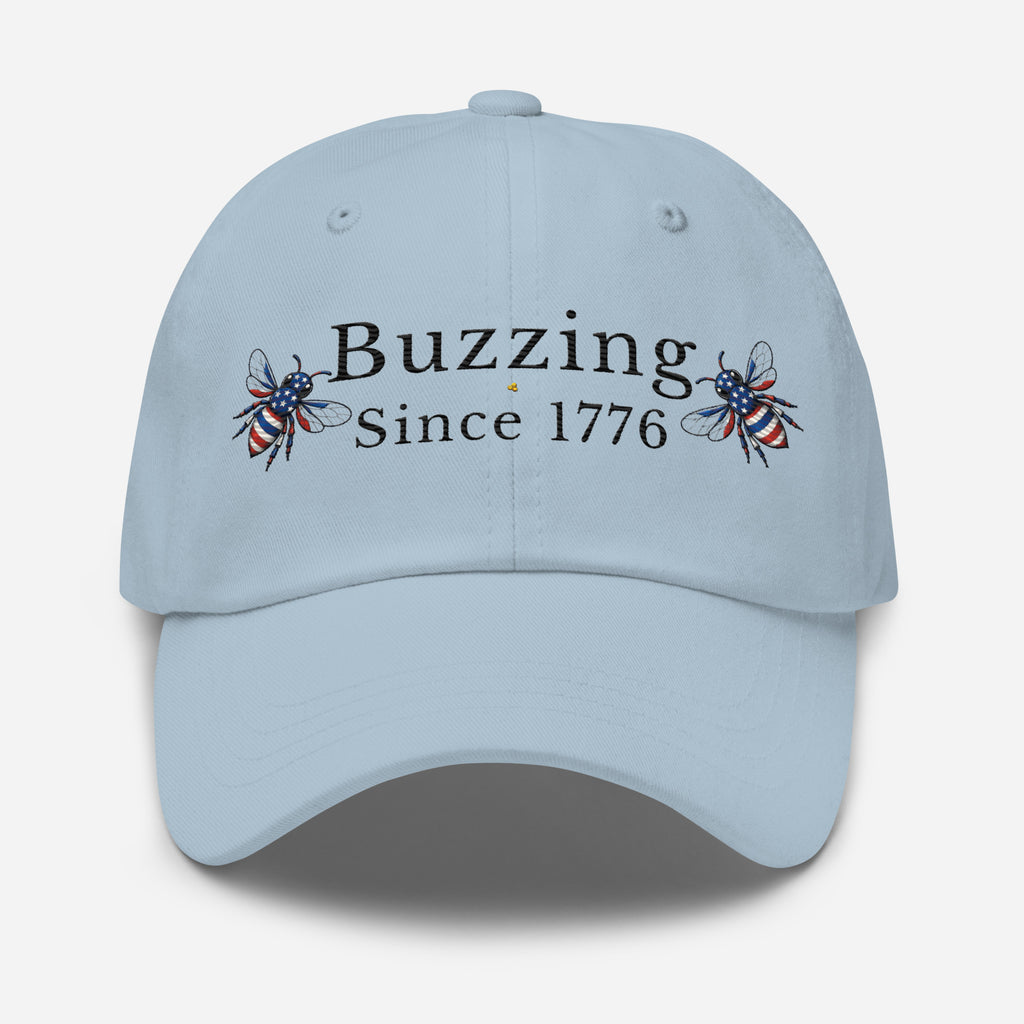 Light blue dad hat with “Buzzing Since 1776” text and bee graphic embroidery on front