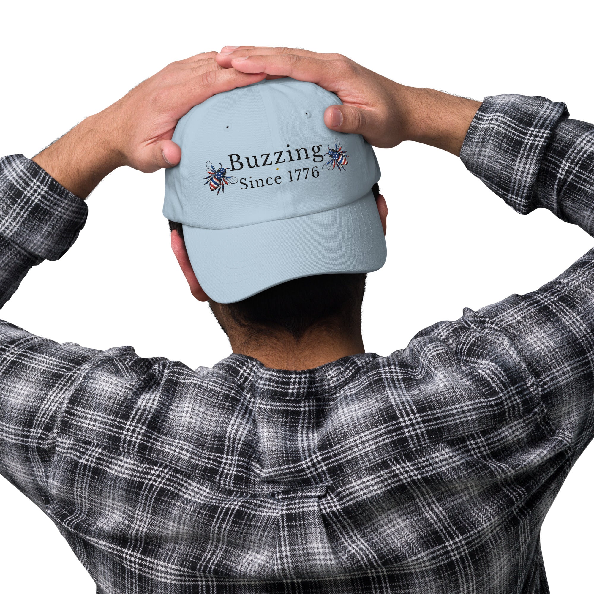 Light blue dad hat with embroidered “Buzzing Since 1776” on back