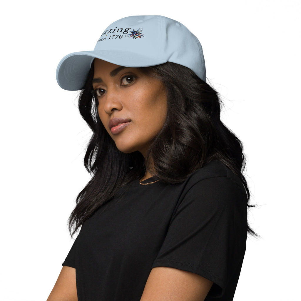 Light blue dad hat with embroidered bee and “Buzzing Since 1776” text