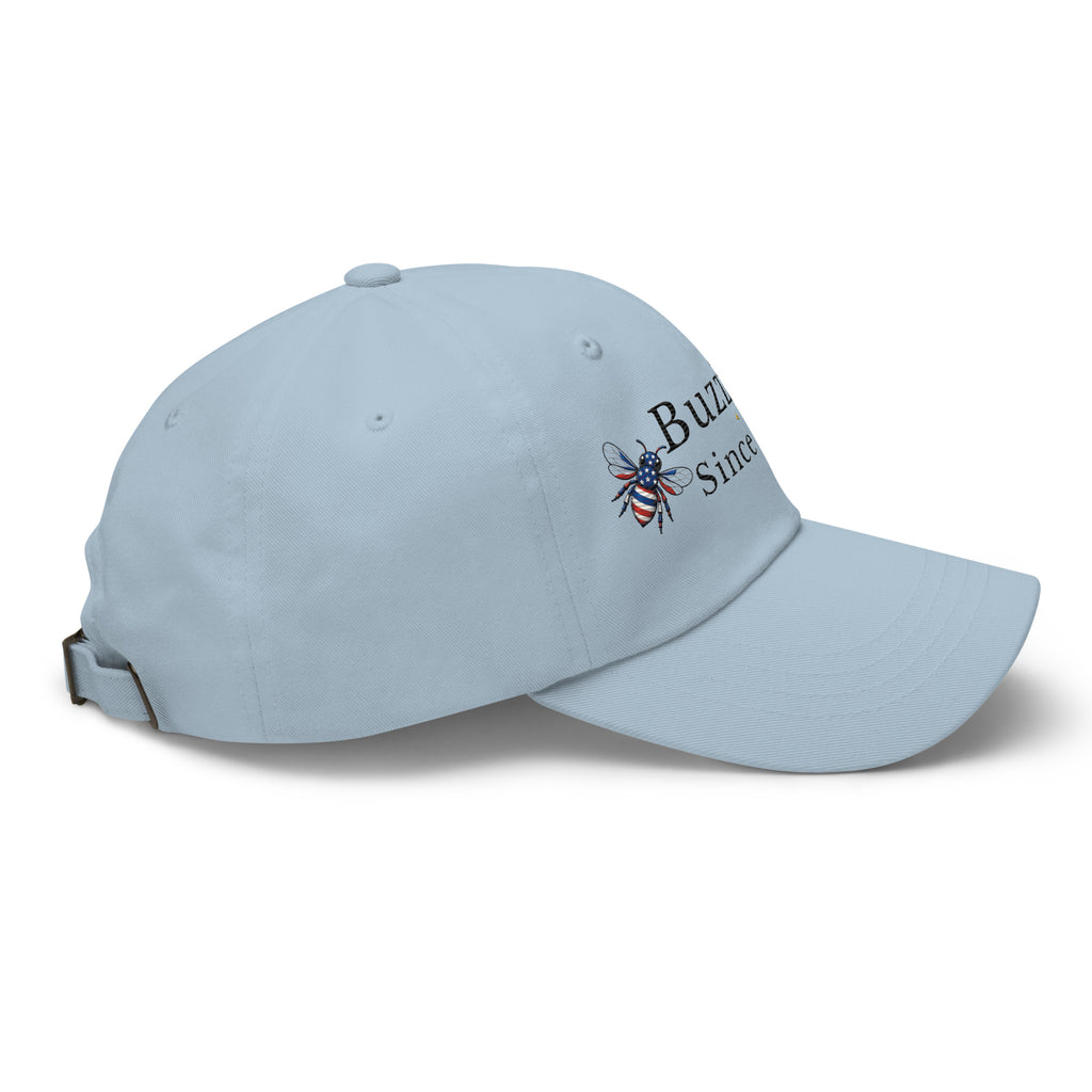 Light blue dad hat with curved brim and embroidered bee graphic on side