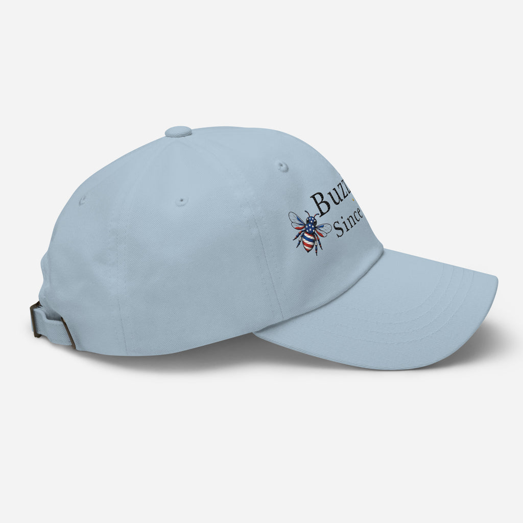 Light blue dad hat with embroidered bee logo on side, curved brim