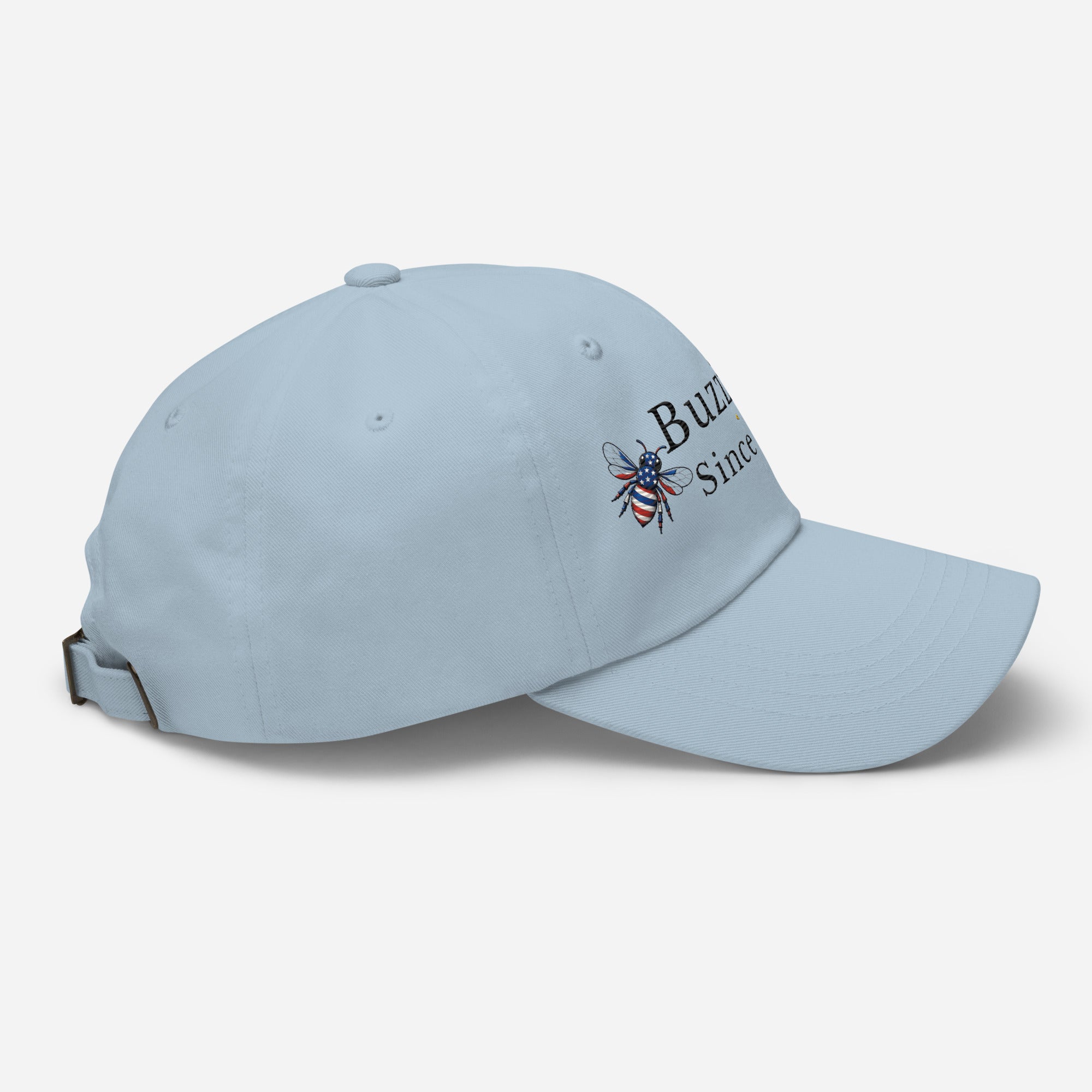 Light blue dad hat with embroidered bee logo on side, curved brim