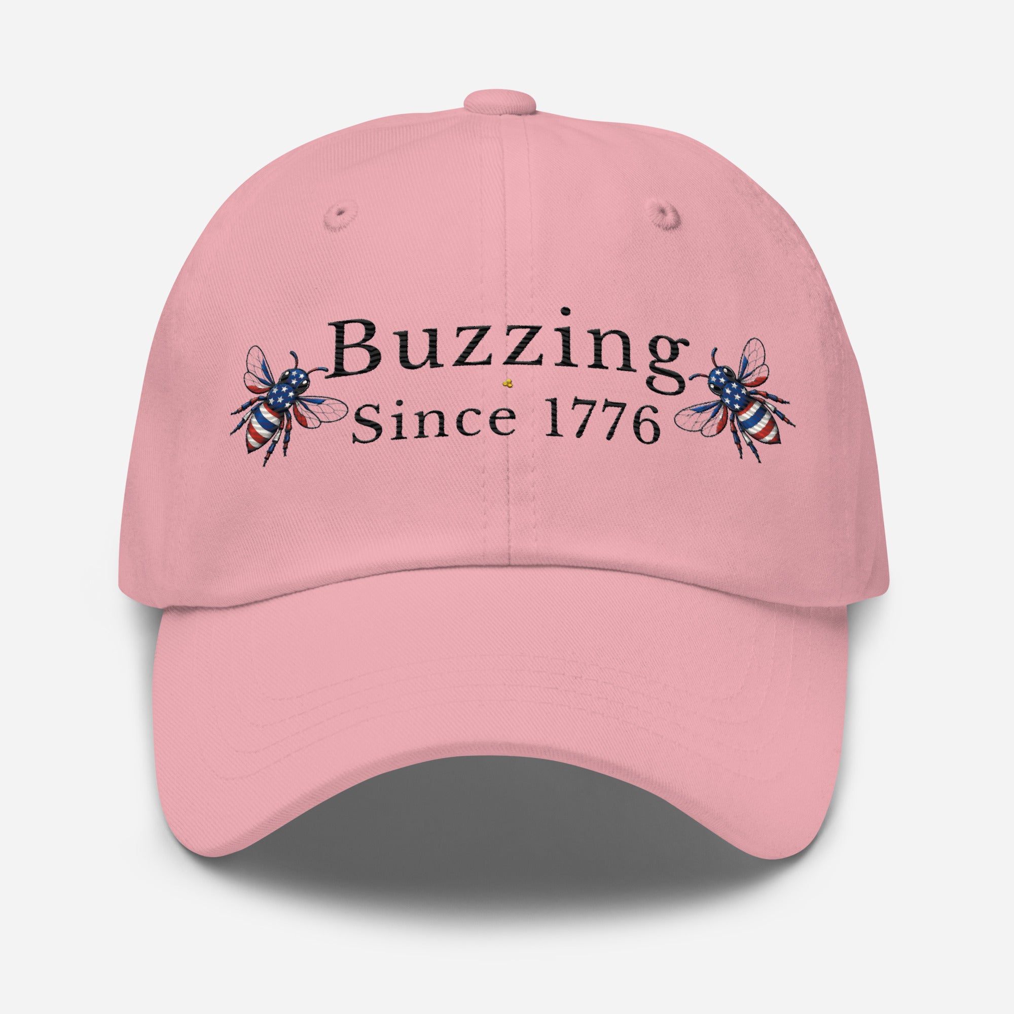 Pink dad hat with “Buzzing Since 1776” text and bee graphic embroidery on front