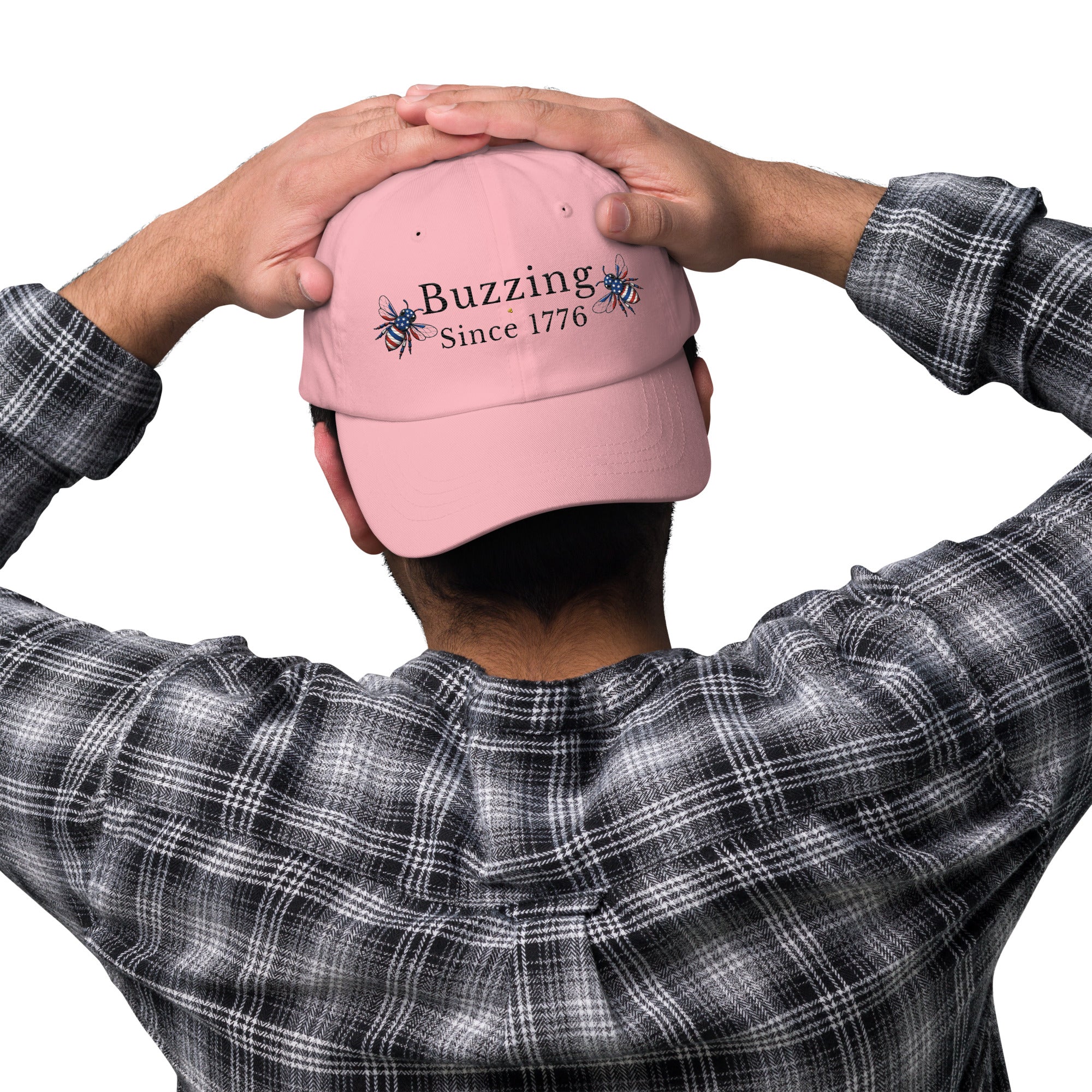 Pink dad hat with embroidered “Buzzing Since 1776” on back