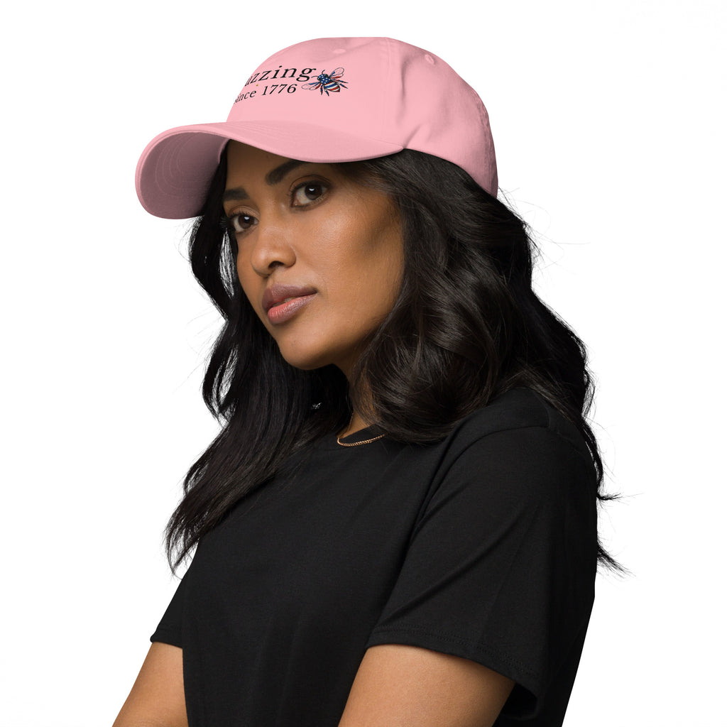 Pink dad hat with embroidered bee and “Buzzing Since 1776” text