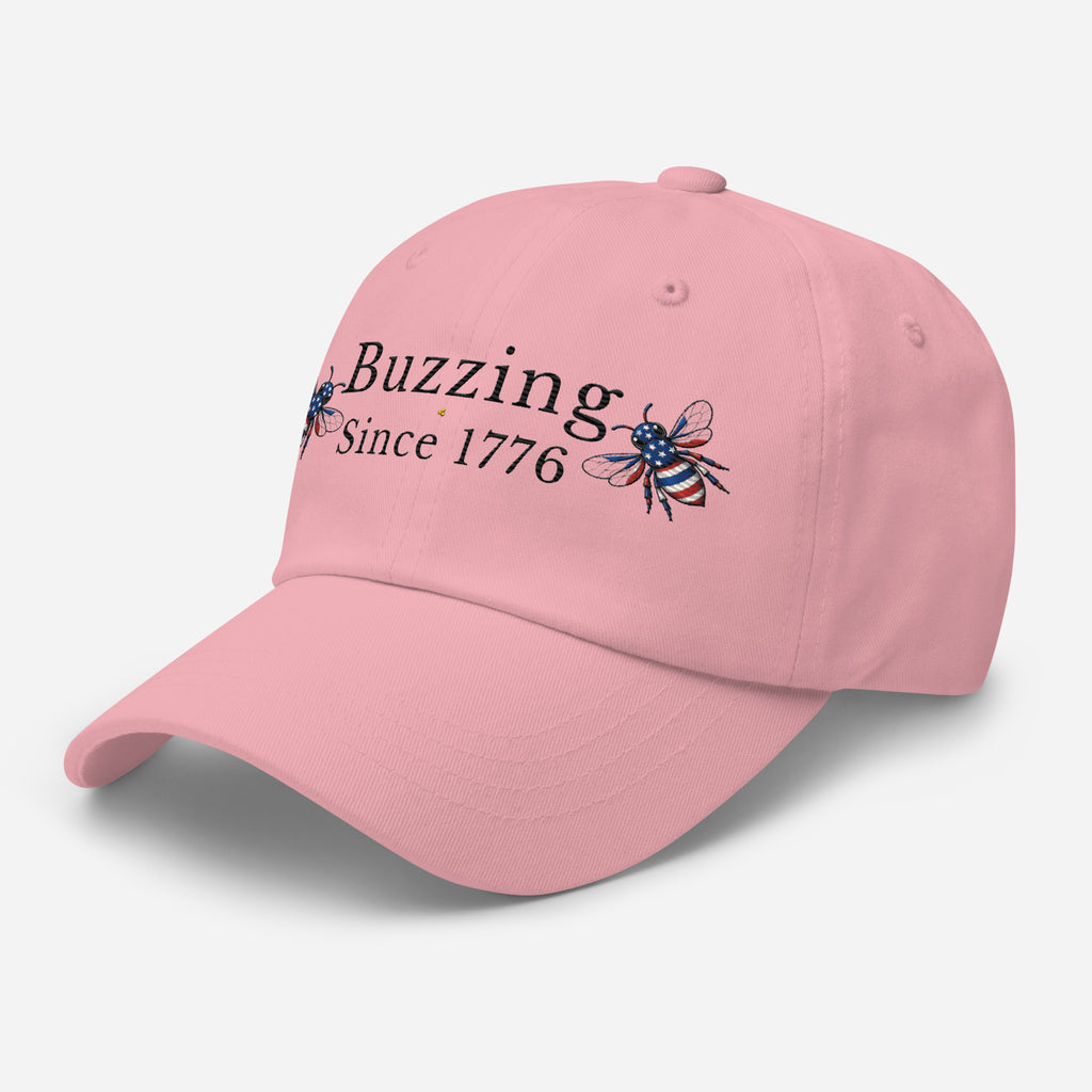 Pink dad hat with embroidered bee and Buzzing Since 1776 text
