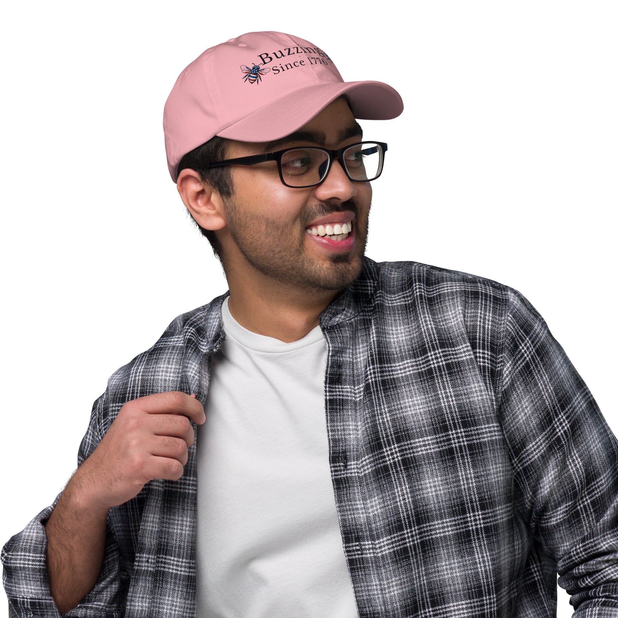 Light pink dad hat with curved brim and embroidered bee “Buzzing Since 1776”
