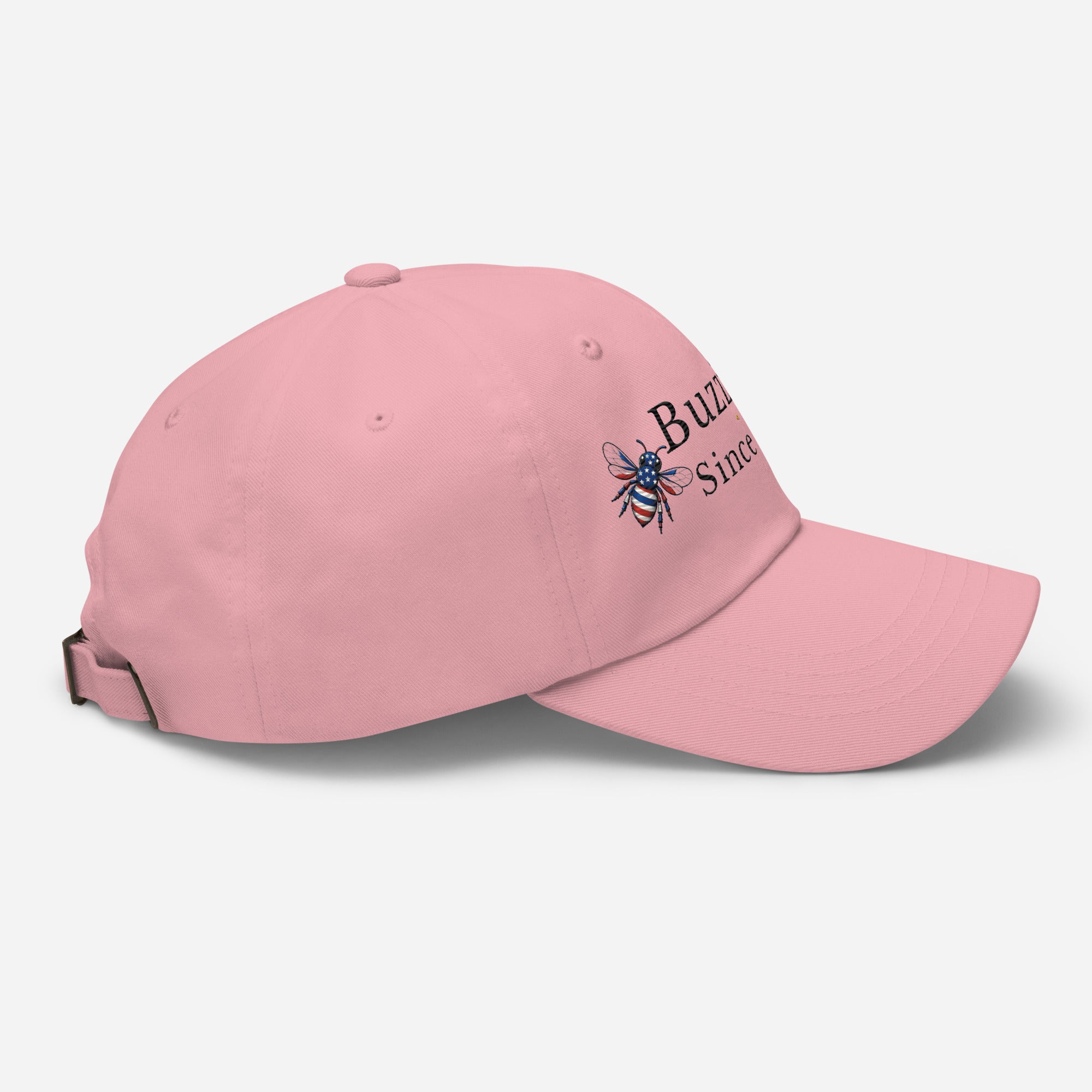 Pink dad hat with embroidered bee logo on side, curved brim