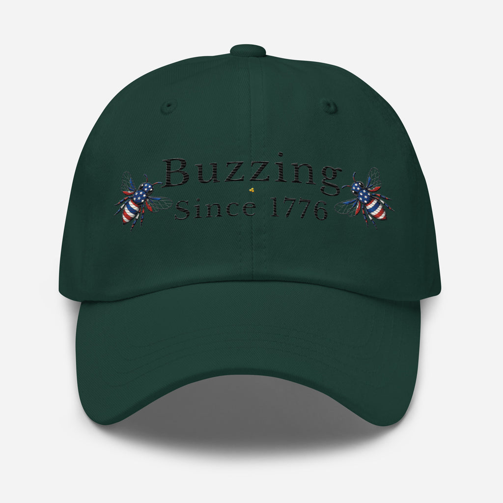 Dark green dad hat with “Buzzing Since 1776” text and bee graphic embroidery on front