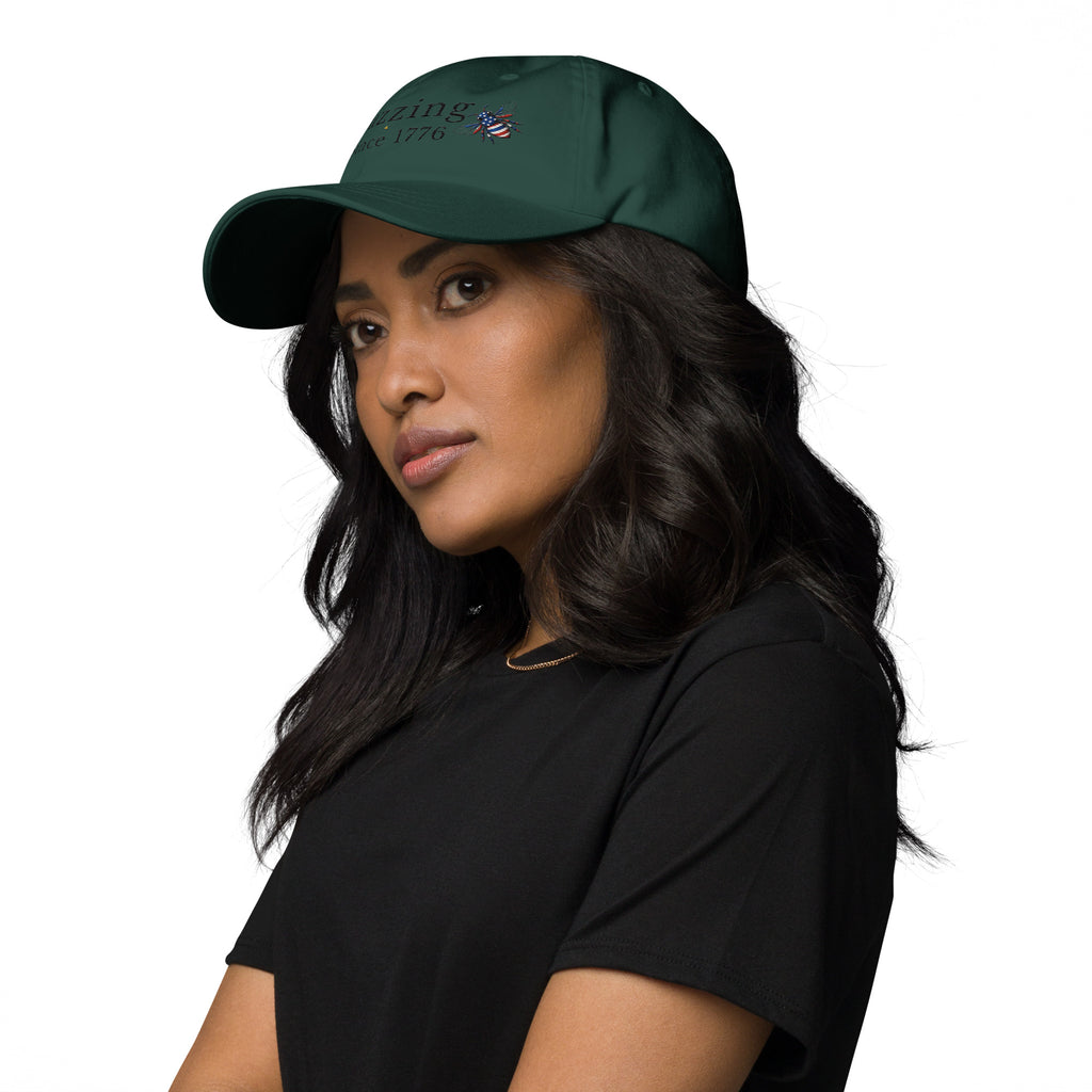 Green dad hat with embroidered text and small bee patch on the front panel.