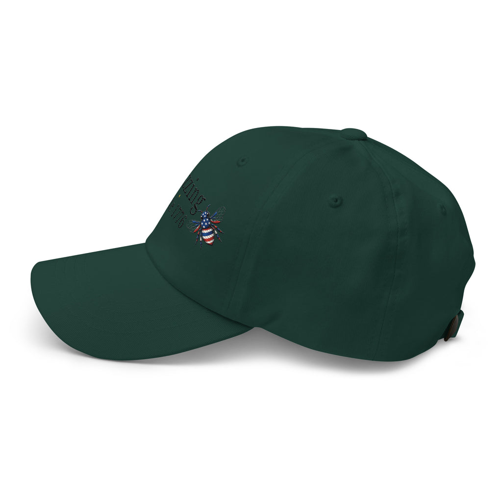 Dark green dad hat with curved brim and embroidered bee graphic on side