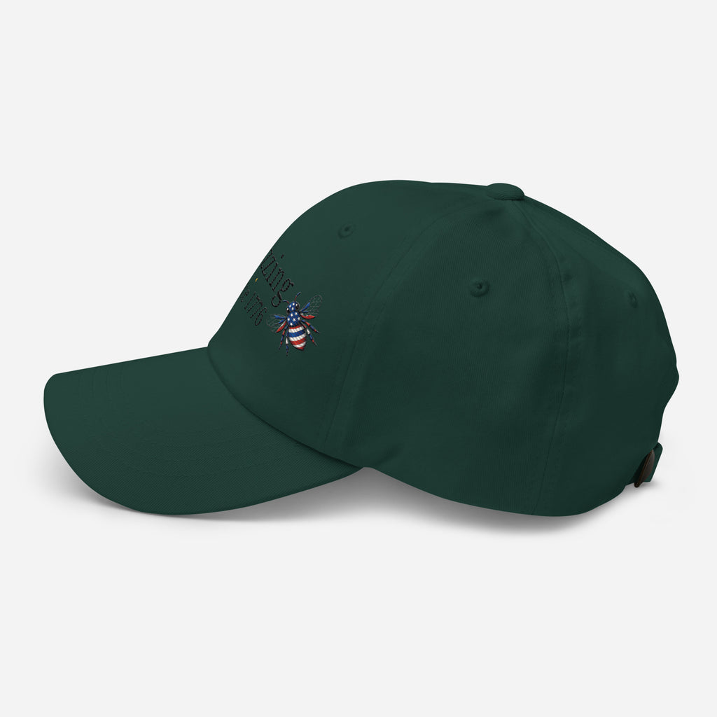 Dark green dad hat with embroidered bee logo on side, curved brim