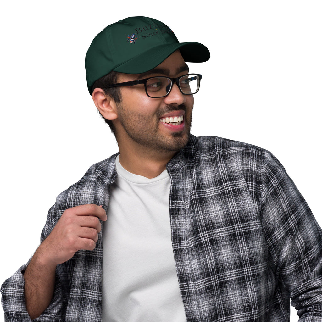 Spruce green dad hat with embroidered bee and “Buzzing Since 1776” text