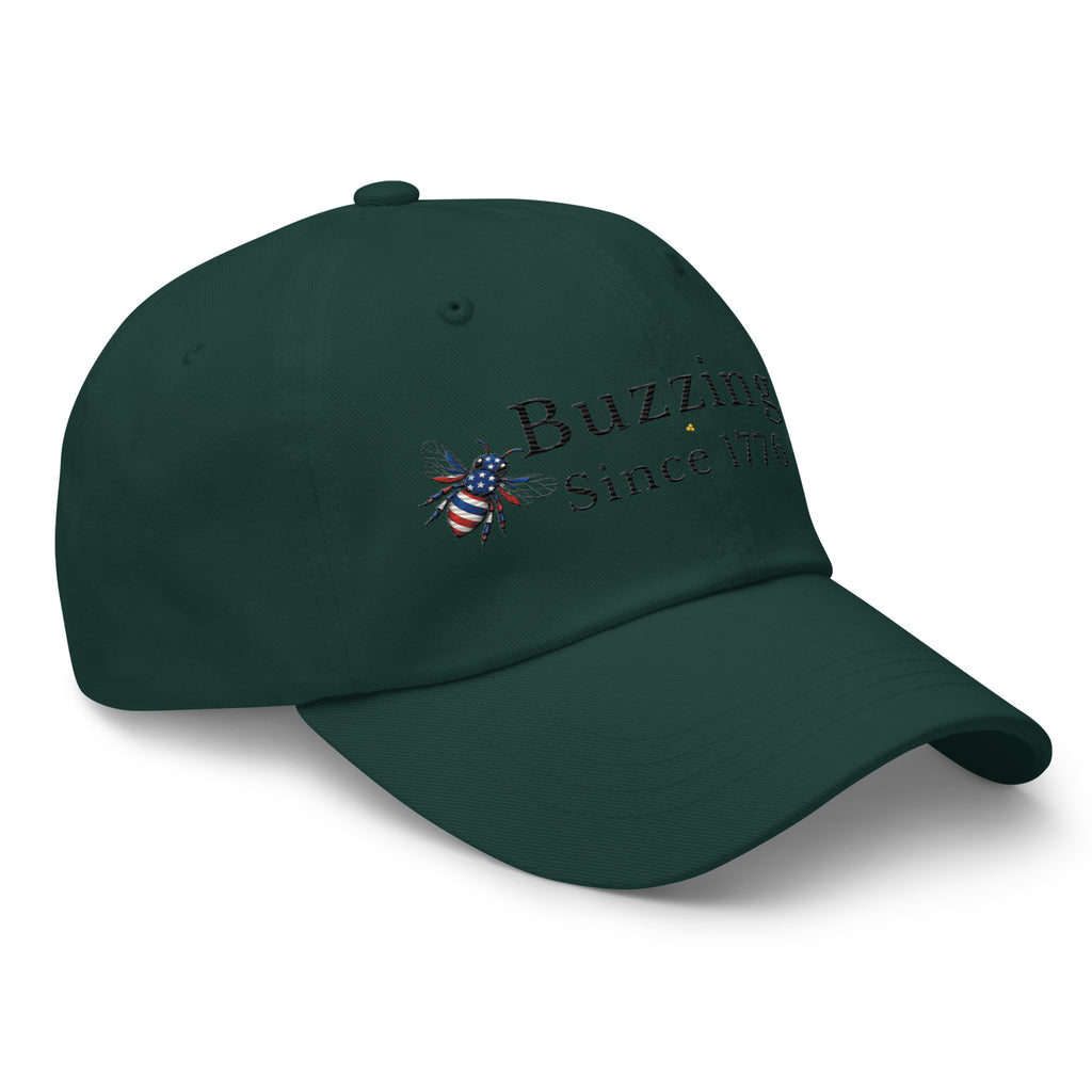 Dark green dad hat with “Buzzing Since 1776” and a centered bee logo