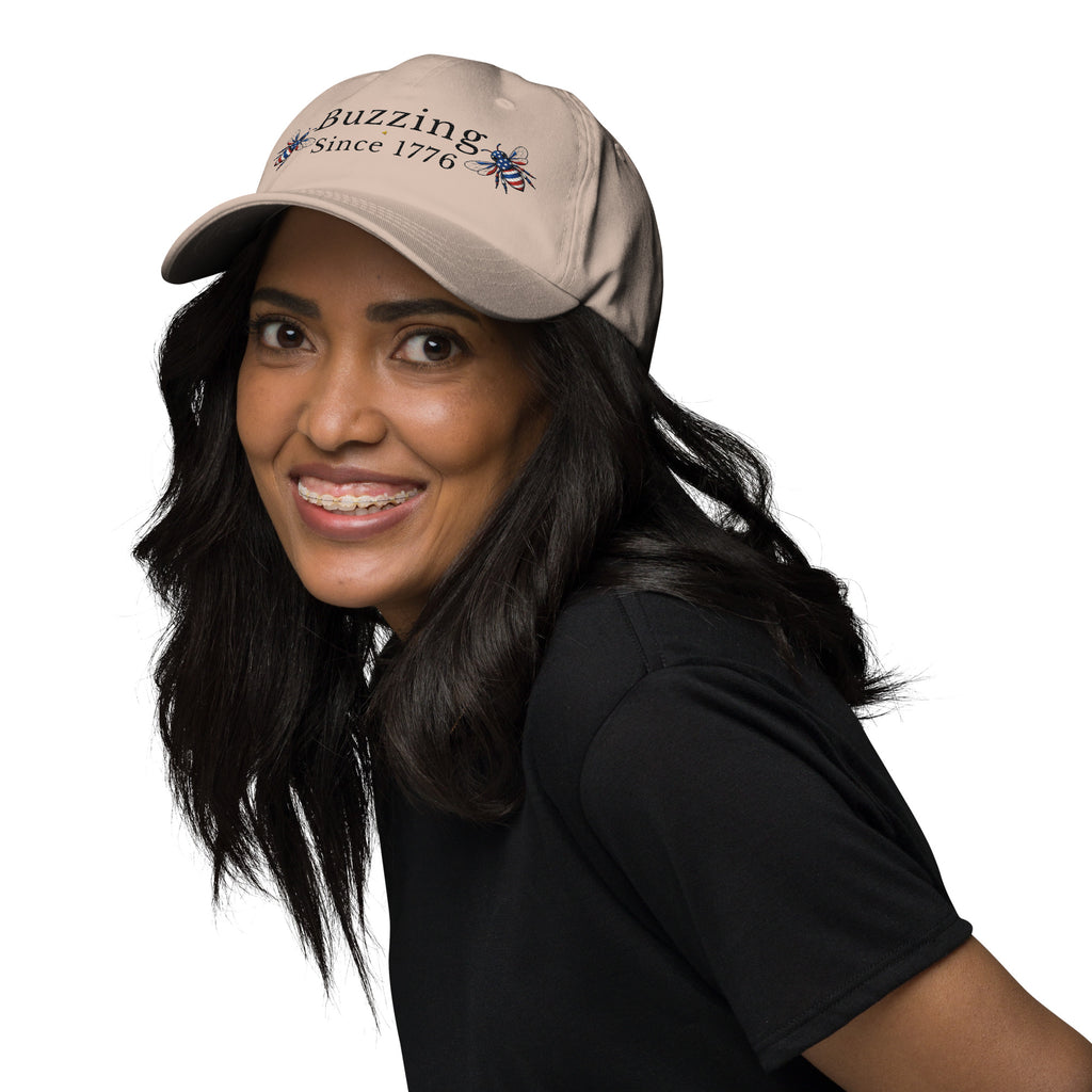 Khaki dad hat with embroidered text and small bee patch, curved brim.