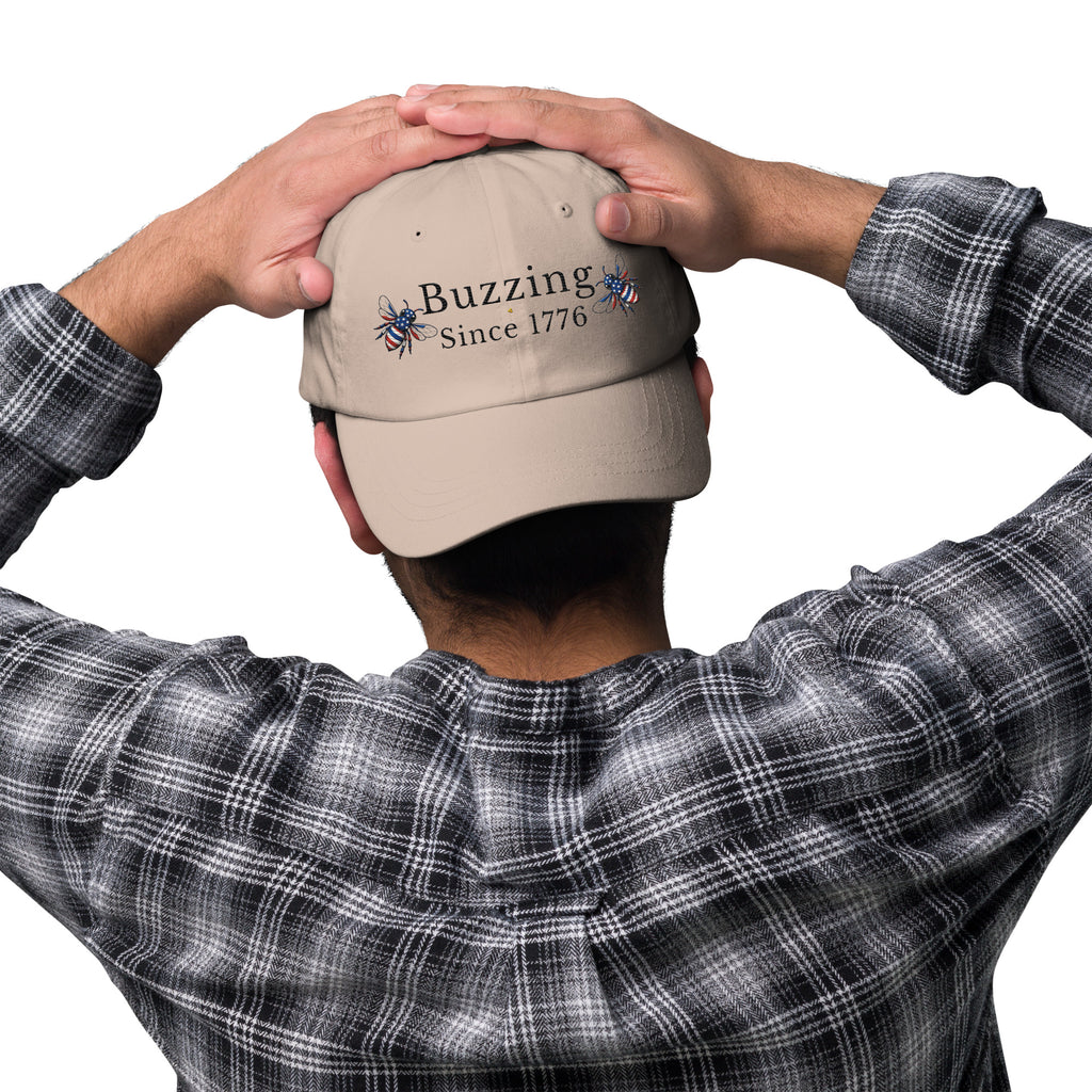 Beige dad hat with embroidered “Buzzing Since 1776” on back