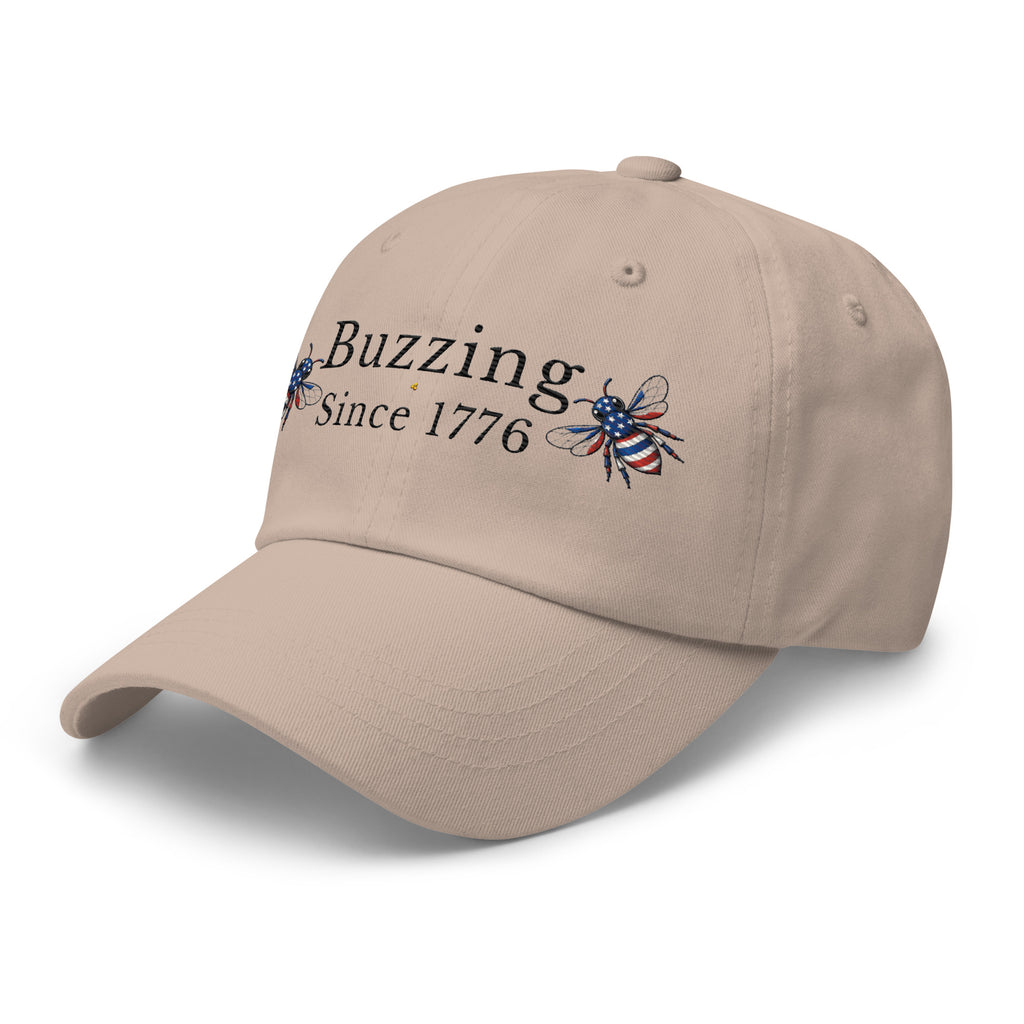 Stone/beige dad hat with “Buzzing Since 1776” and bee graphic