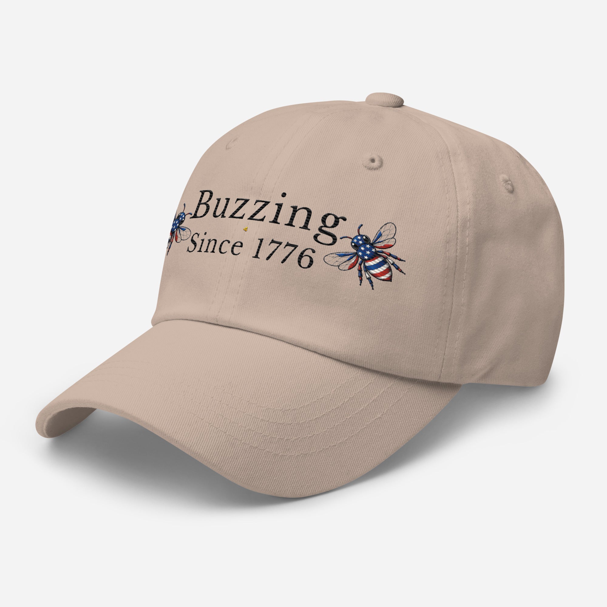 Stone/beige dad hat with embroidered bee and Buzzing Since 1776 text