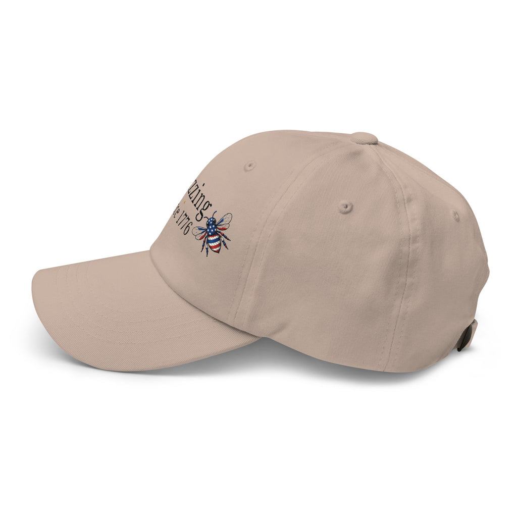 Sand dad hat with curved brim and embroidered bee graphic on side
