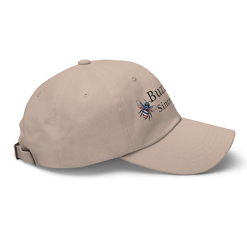 Tan dad hat with curved brim and embroidered bee graphic on side
