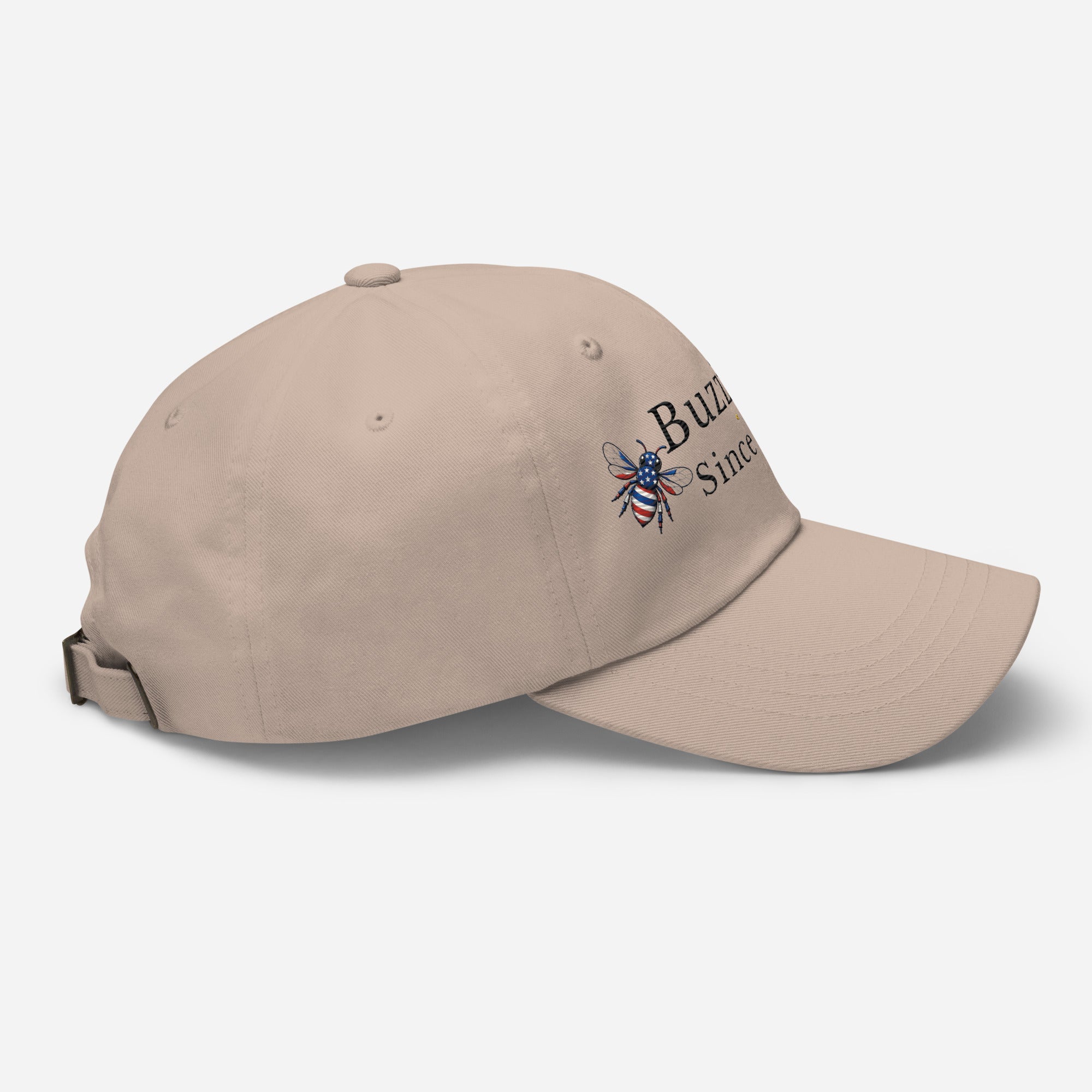 Beige dad hat with embroidered bee logo on side, curved brim