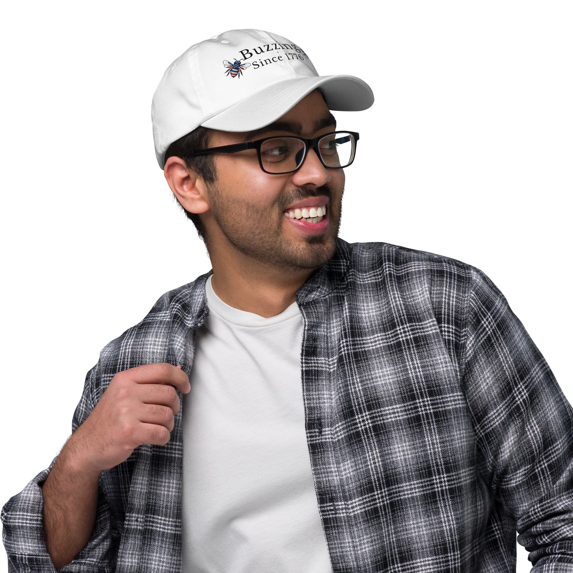 White dad hat with embroidered “Buzzing Since 1776” on front