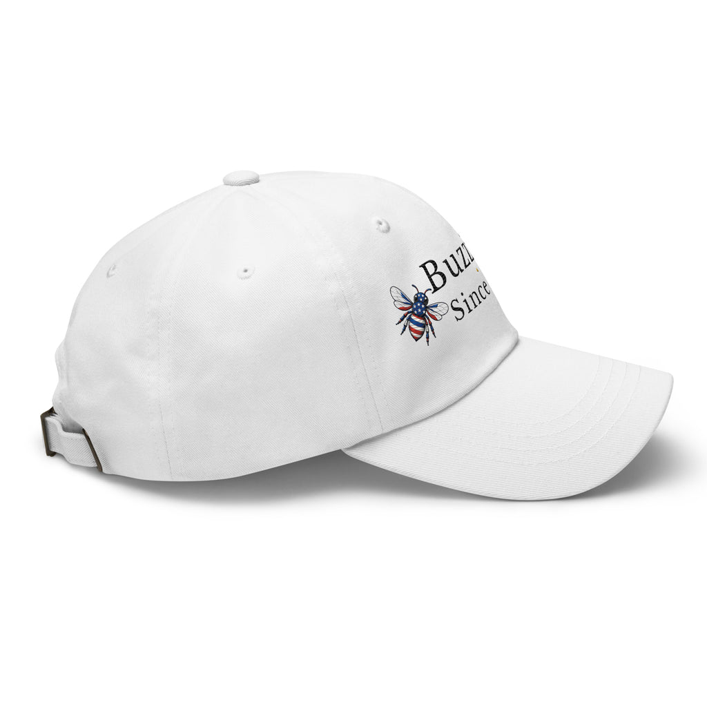 White dad hat with curved brim and embroidered bee graphic on side
