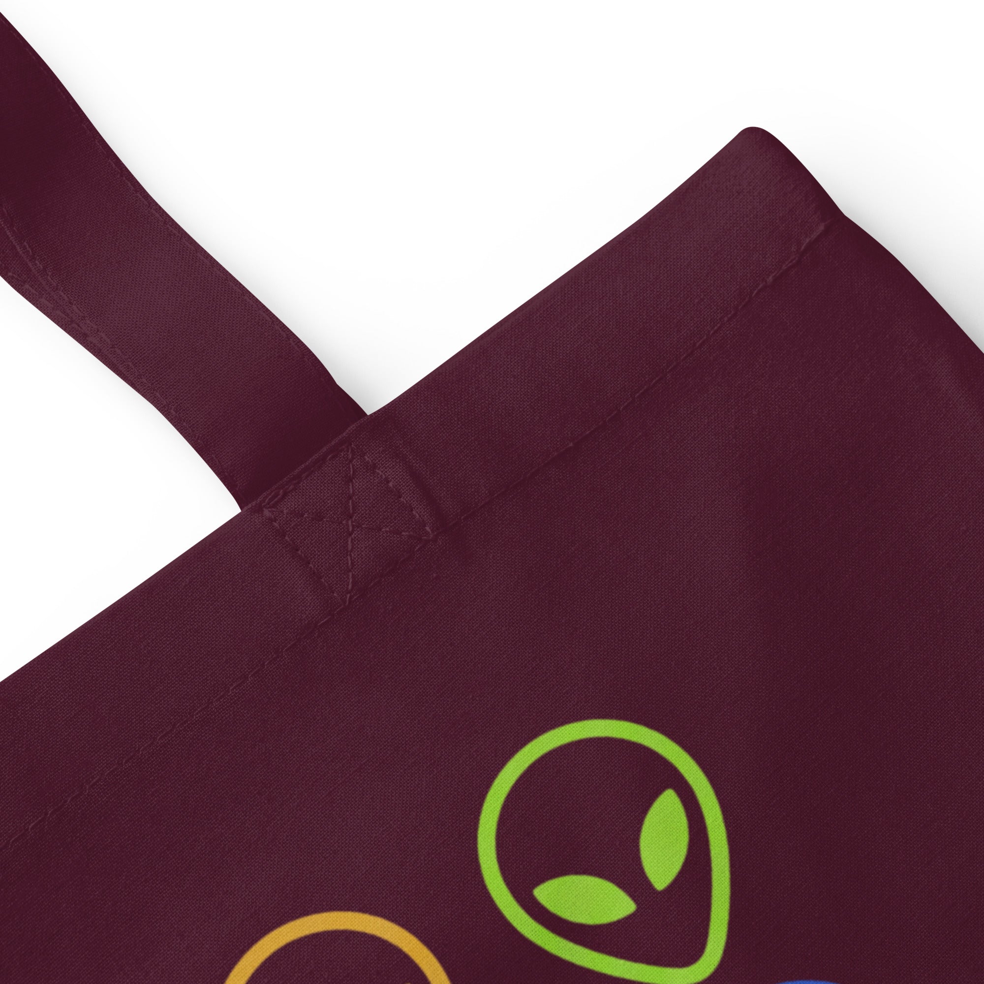 Burgundy cotton tote bag with alien face graphic patch on front