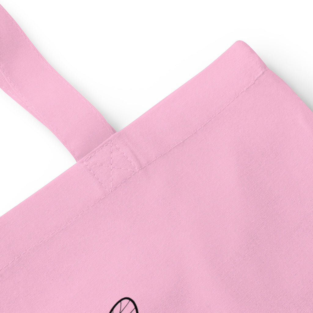Pink cotton tote bag close-up of reinforced handle stitching and seam