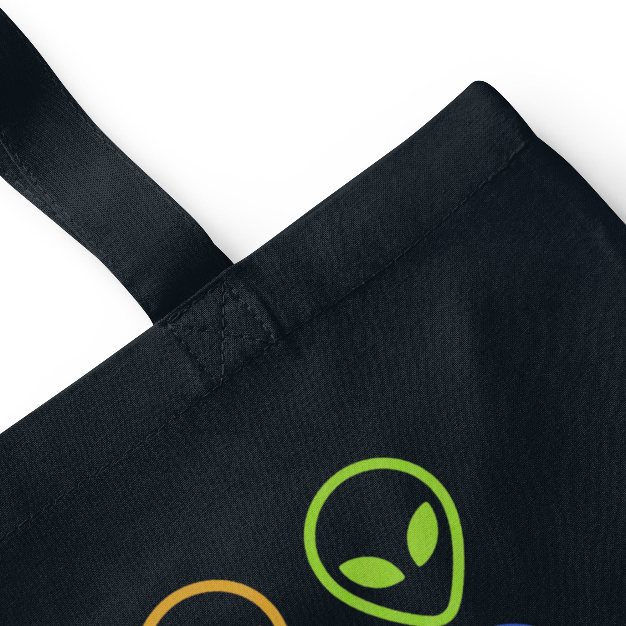 French navy cotton tote bag close-up of strap seam and green alien face graphic.