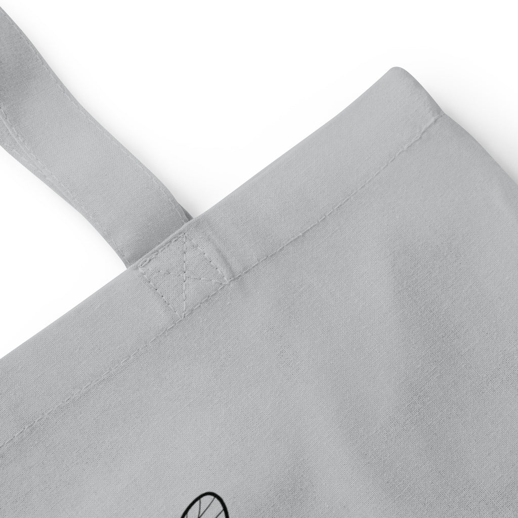 Light grey cotton tote bag close-up of reinforced handle stitching and seam