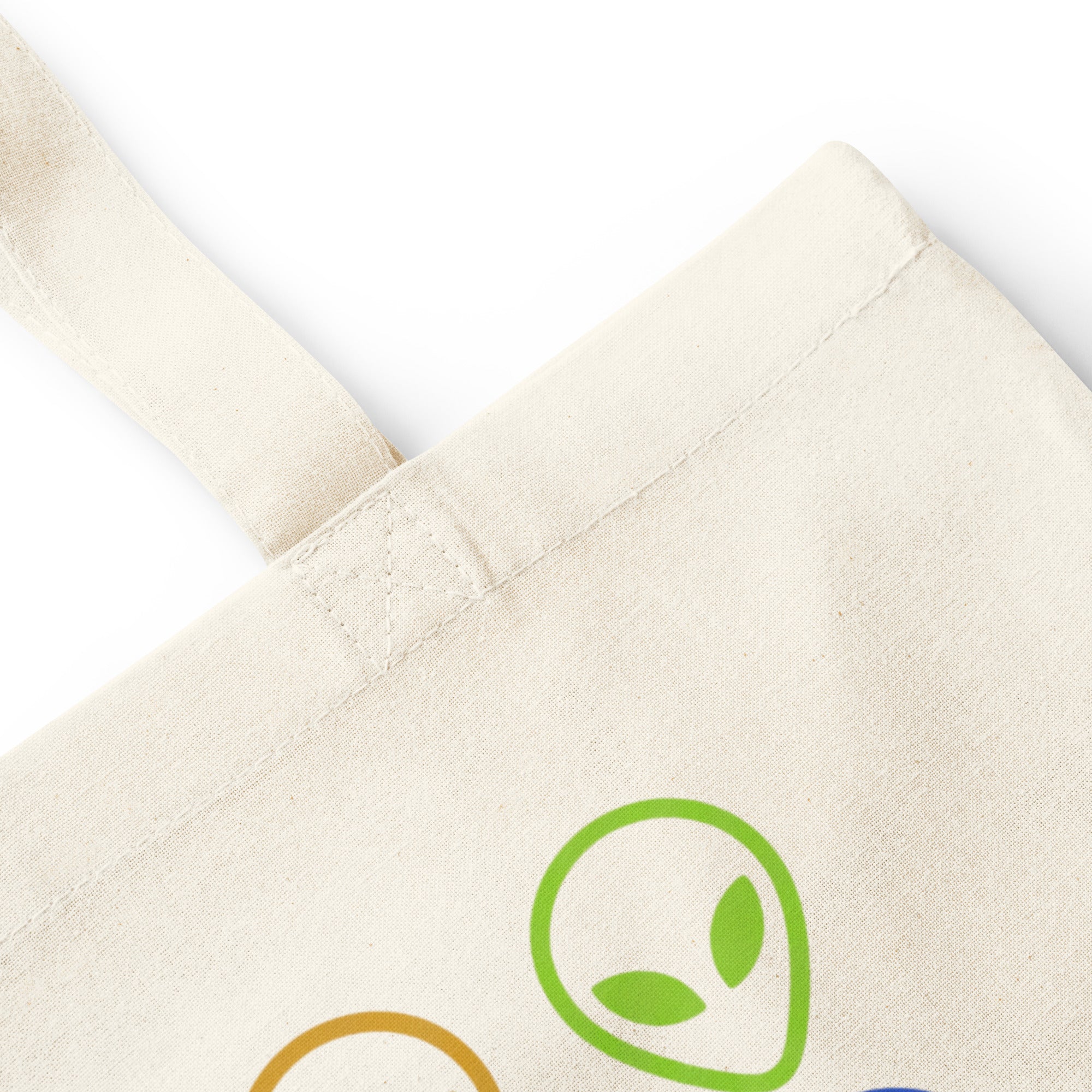 Natural cotton tote bag with alien face graphic patch on front
