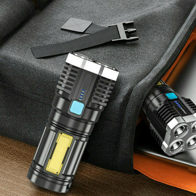Black tactical flashlight on fabric with blue display and charging port visible