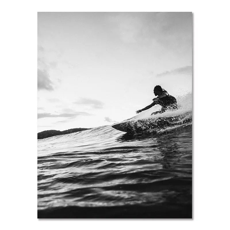 Black-and-white wall poster of surfer kicking up spray while riding a wave