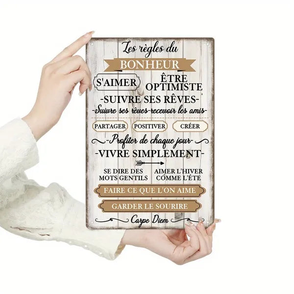 French inspirational metal wall sign with quote text, distressed cream finish, held by hands