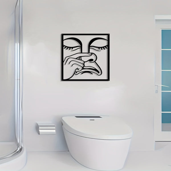 Square metal wall art on a white wall with black line nose-picking face design