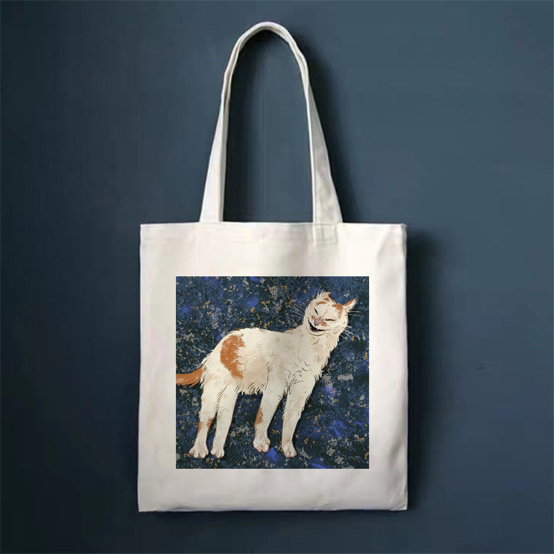 Canvas tote bag with standing cat illustration on front panel and top handles.