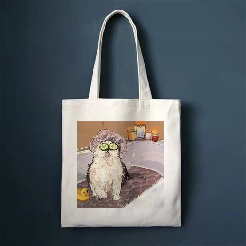Canvas tote bag with white cat on rug illustration and top handles.