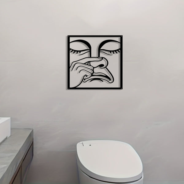 Square metal wall art on light wall with black line nose-picking face design