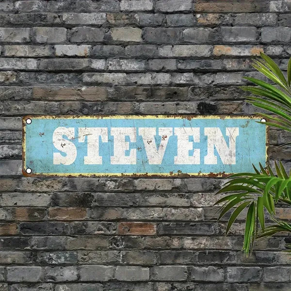 Vintage aluminum name plate sign reading STEVEN, blue distressed finish, metal border.