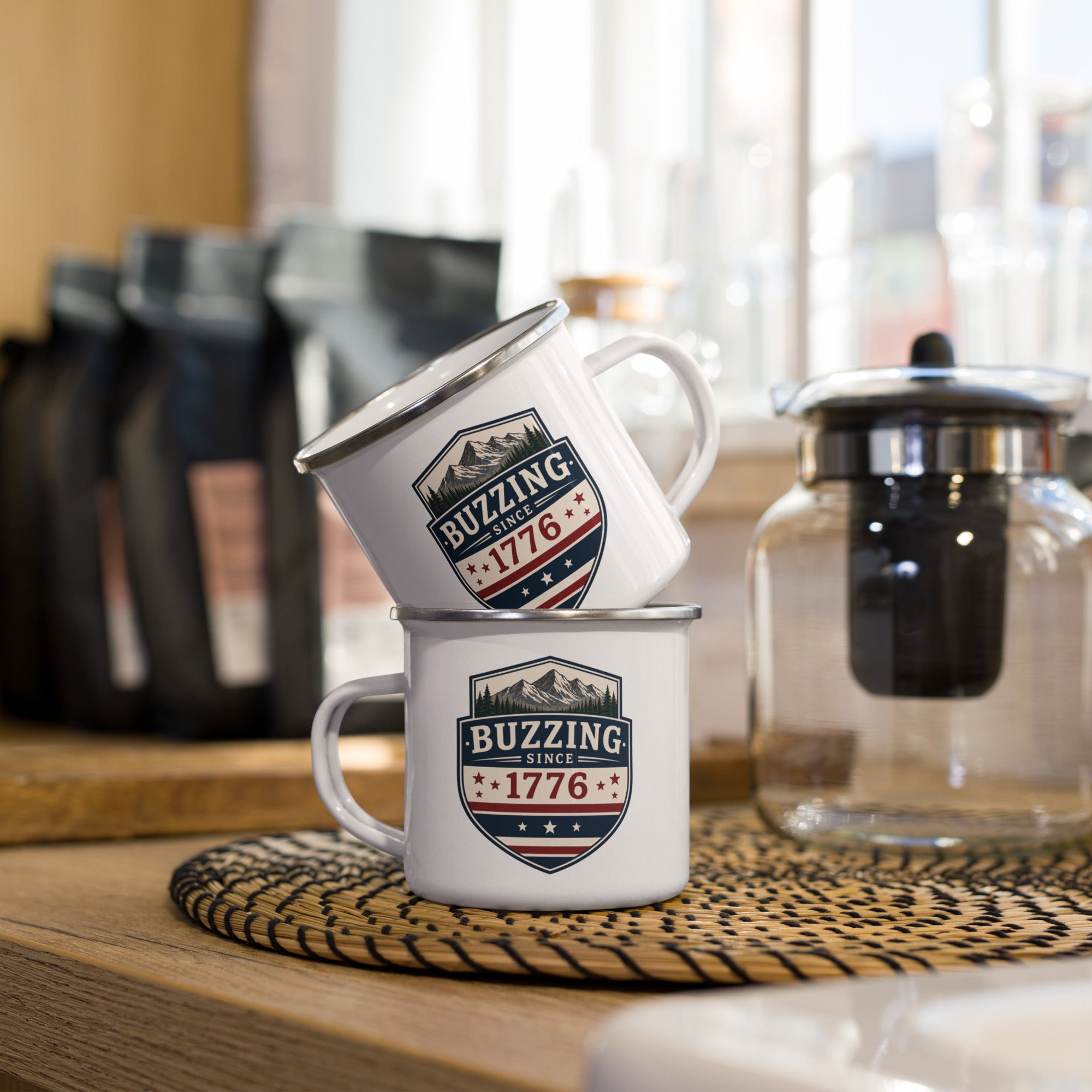 Enamel mug with white body and blue shield logo reading “Buzzing Since 1776”