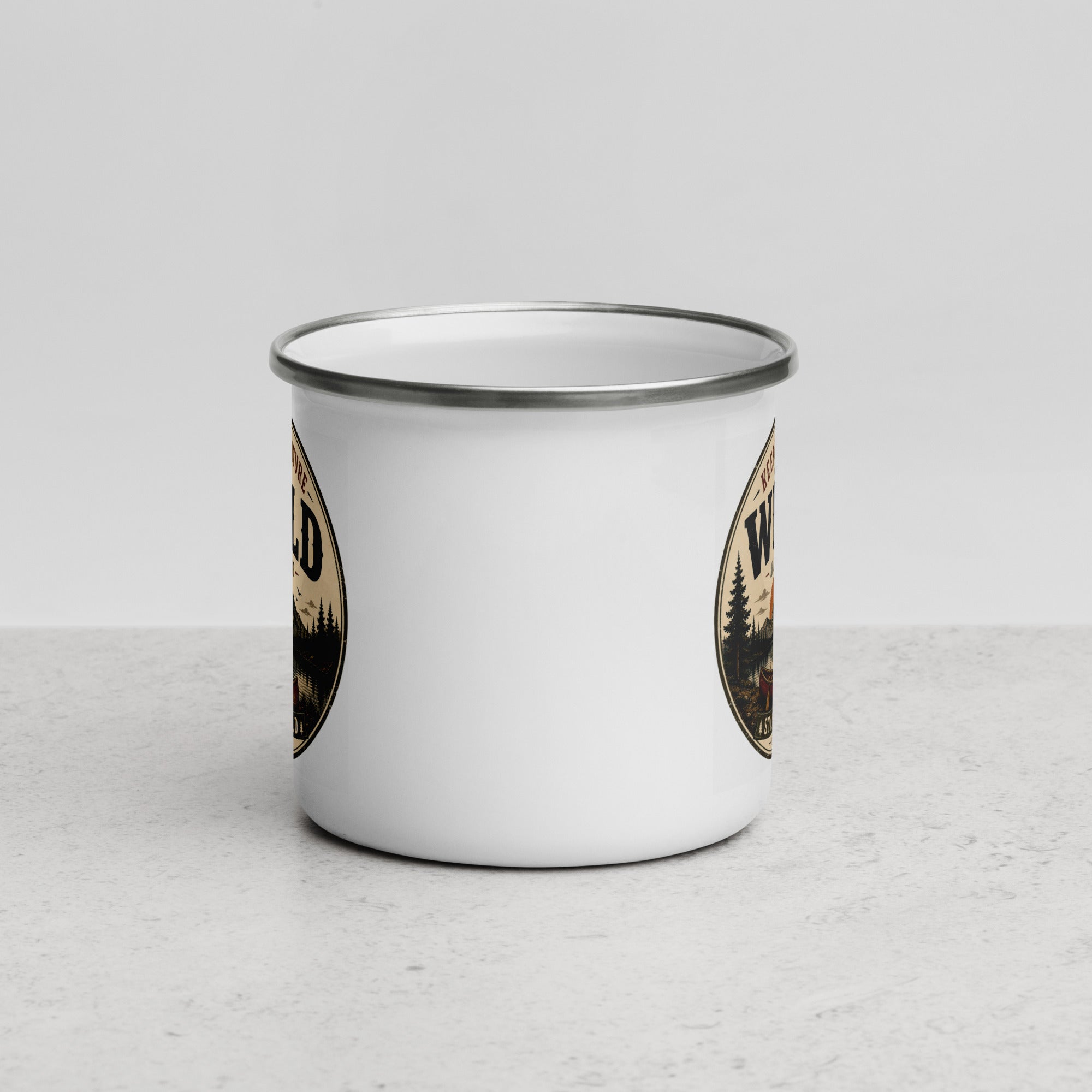 White enamel mug with gray rim and partial Wild logo on side
